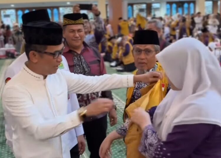 Wali Kota Balikpapan, Rahmad Mas’ud, secara simbolis melepas keberangkatan jemaah dengan mengenakan rompi kepada jemaah tertua dan termuda